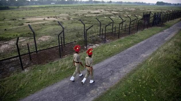 Border Security Force personnel patrol near a fence on the India- Bangladesh border at Thakuranbari village, in the northeastern Indian state of Assam.(AP File) Border Security Force personnel patrol near a fence on the India- Bangladesh border at Thakuranbari village, in the northeastern Indian state of Assam.(AP File)