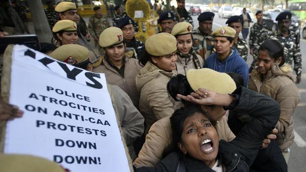 Delhi Police personnel detain a protester for shouting slogans to release Indian peasant leader and RTI activist from Assam Akhil Gogoi during a protest against CAA, outside Assam Bhawan, at Sardar Patel Marg, in New Delhi. (Biplov Bhuyan / HT Photo)