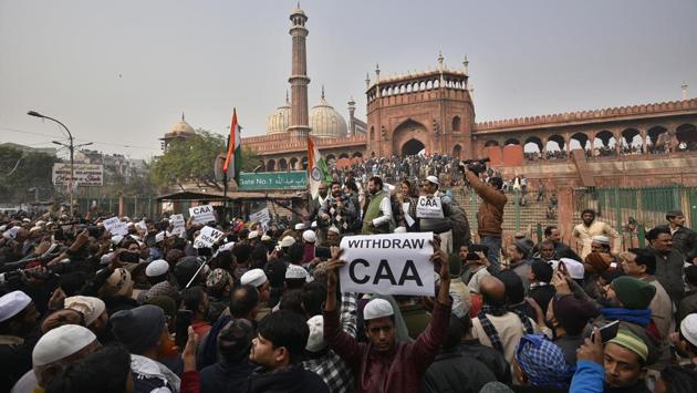 People hold placards during a protest against CAA after Friday prayers at Jama Masjid in the old quarters of Delhi. (Biplov Bhuyan / HT Photo)