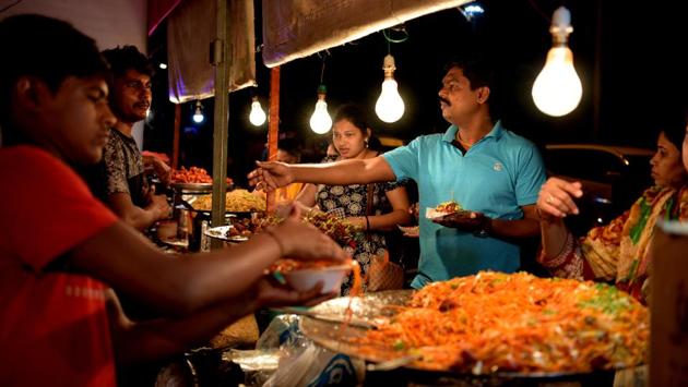 Visitors buy food at a stall during the Chowpatty Festival at Mini Seashore Ground, Vashi, in Navi Mumbai, Maharashtra. 58 food stalls and a floating stage have been placed at the venue. (Bachchan Kumar / HT Photo)