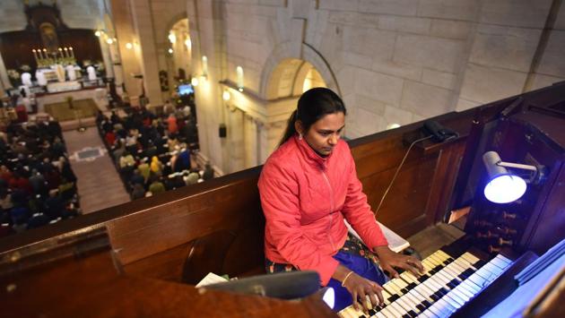 A woman plays organ music as people attend morning prayers and Christmas Day mass at the Church of Redemption, Rashtrapati Bhawan, in New Delhi. (Sanchit Khanna / HT Photo)