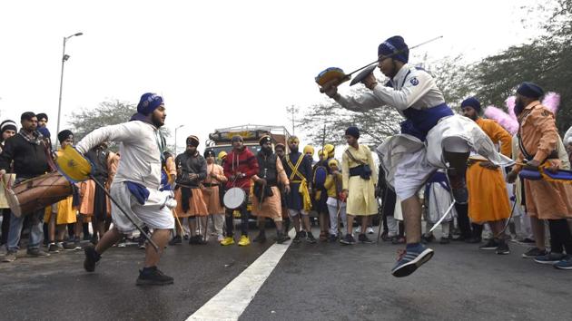 Devotees perform Gatka during Nagar Kirtan ahead of the birth anniversary of Guru Gobind Singh ji, the tenth Sikh Guru, near Shankar road in New Delhi. (Arvind Yadav / HT Photo)