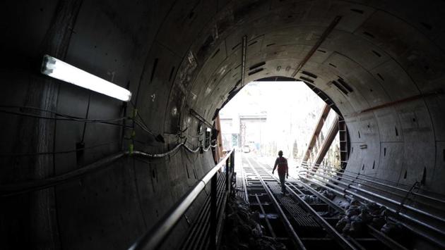 A worker walks on the tracks of the under-construction Maha Metro, at Agriculture College Ground in Pune, Maharashtra. (Rahul Raut / HT Photo)