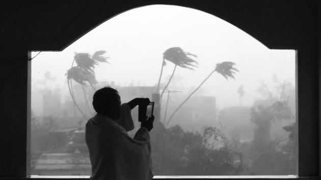 A man takes photos as cyclone Fani makes landfall in Puri, Odisha, on May 3. Cyclone Fani, which barrelled through Odisha, claimed at least 64 lives and rendered over five lakh homeless. The coastal regions of Andhra Pradesh and West Bengal were also impacted by the cyclone. (Arijit Sen/HT Photo) A man takes photos as cyclone Fani makes landfall in Puri, Odisha, on May 3. Cyclone Fani, which barrelled through Odisha, claimed at least 64 lives and rendered over five lakh homeless. The coastal regions of Andhra Pradesh and West Bengal were also impacted by the cyclone. (Arijit Sen/HT Photo)