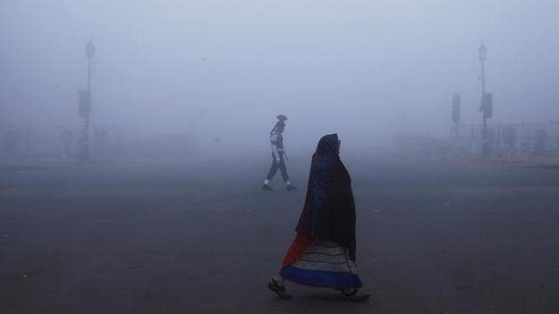 A woman wraps herself in a shawl as she walks past a soldier during a Republic Day parade rehearsal on a foggy winter morning in New Delhi. “The day temperature till 1430 IST today has been unusual following the coldest trend with Safdarjung at 1430 IST at 9.4 degree Celsius and Palam at 9 degrees Celsius,” the weather department said in a statement. (Adnan Abidi / REUTERS) A woman wraps herself in a shawl as she walks past a soldier during a Republic Day parade rehearsal on a foggy winter morning in New Delhi. “The day temperature till 1430 IST today has been unusual following the coldest trend with Safdarjung at 1430 IST at 9.4 degree Celsius and Palam at 9 degrees Celsius,” the weather department said in a statement. (Adnan Abidi / REUTERS)