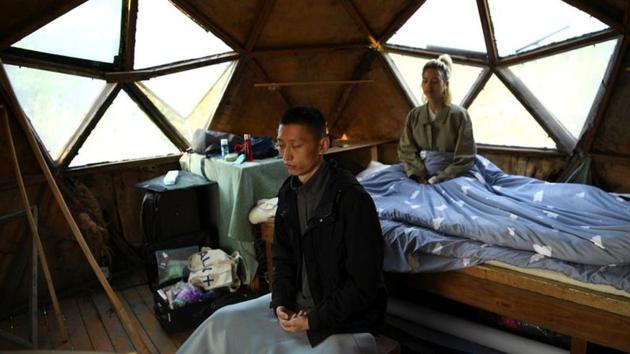 Yang Zhaoyu and Chen Yan meditate in the early morning inside a dome shaped house on a hill at AnotherCommunity. Yang Zhaoyu quit his job in a big Chinese city nine months ago and moved to a small community that preaches sustainable living and mindful consumption. “After graduating from college, I lived a very mainstream life,” the 30-year-old former software developer told Reuters. “I dated, got married, and found a job.” (Tingshu Wang / REUTERS)