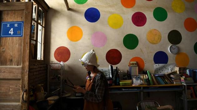 Xing Zhen cooks lunch for her weaving class students at AnotherCommunity in Guanzhong village. Chinese media is full of stories about people seeking alternative lifestyles in the countryside. (Tingshu Wang / REUTERS)