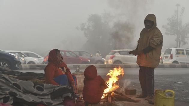 People warm themselves near a bonfire during a cold and foggy morning in New Delhi. It also said that the lowest maximum temperature so far has been recorded on December 28, 1997, when the mercury had plunged to 11.3 degree Celsius, the IMD said. (PTI) People warm themselves near a bonfire during a cold and foggy morning in New Delhi. It also said that the lowest maximum temperature so far has been recorded on December 28, 1997, when the mercury had plunged to 11.3 degree Celsius, the IMD said. (PTI)