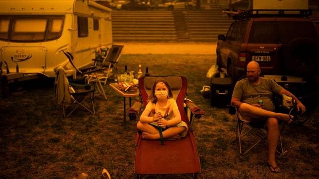 Amy (L) and Ben Spencer sit at the showgrounds in the southern New South Wales town of Bega where they are camping after being evacuated from nearby sites affected by bushfires. AFP reports that dozens of properties were feared to have been destroyed since late Monday and at least seven people were unaccounted for in New South Wales and Victoria states as flames reached well-populated towns like Batemans Bay. (Sean Davey/AFP) Amy (L) and Ben Spencer sit at the showgrounds in the southern New South Wales town of Bega where they are camping after being evacuated from nearby sites affected by bushfires. AFP reports that dozens of properties were feared to have been destroyed since late Monday and at least seven people were unaccounted for in New South Wales and Victoria states as flames reached well-populated towns like Batemans Bay. (Sean Davey/AFP)
