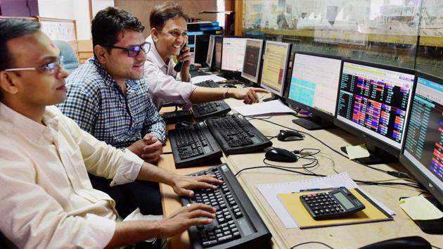 Traders reacts as Sensex reached 30,000 mark on December 31, in Mumbai.(PTI Photo)