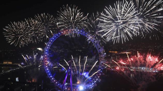 Fireworks explode over the London Eye Ferris wheel by the River Thames in London, to mark the start of the new year, Wednesday, Jan. 1, 2020. (Aaron Chown/PA via AP) (AP) 