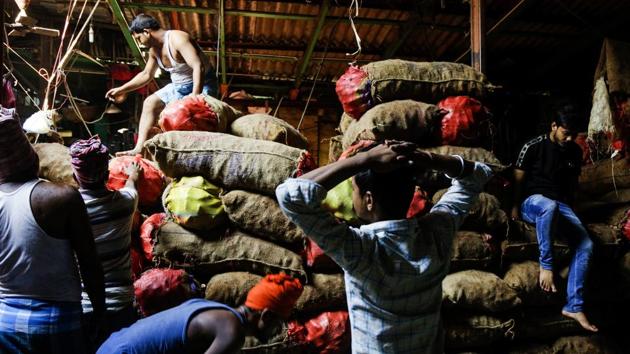 Indian laborers work at a wholesale vegetable market in Kolkata. Hanke opined that Modi government seems to have little interest in making tough and required economic reforms. (AP) Indian laborers work at a wholesale vegetable market in Kolkata. Hanke opined that Modi government seems to have little interest in making tough and required economic reforms. (AP)