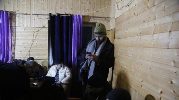 A Kashmiri journalist checks his cellphone at a media facilitation centre in Srinagar. (AP) A Kashmiri journalist checks his cellphone at a media facilitation centre in Srinagar. (AP)