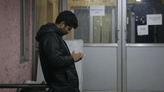 A man checks his cellphone outside a media facilitation centre in Srinagar,Jammu & Kashmir, Tuesday, Dec. 31, 2019. (AP) A man checks his cellphone outside a media facilitation centre in Srinagar,Jammu & Kashmir, Tuesday, Dec. 31, 2019. (AP)
