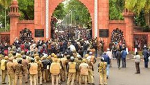 Police personnel stand guard outside Aligarh Muslim University (AMU) as students protest against the passing of Citizenship Amendment Bill, in Aligarh(PTI) Police personnel stand guard outside Aligarh Muslim University (AMU) as students protest against the passing of Citizenship Amendment Bill, in Aligarh(PTI)