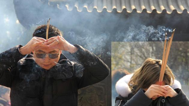 People holding incense sticks as they offer prayers at the Longhua Temple in Shanghai. Hong, a Buddhist, says there is at least one Buddhist temple in every village in Yongchun and Quanzhou. “Incense used for paying respects to Buddha is still the main type we produce as it’s a legacy of our forefathers. We’re also diversifying our incense varieties to serve multiple purposes like home air freshening or aromatherapy,” Hong said. (Hector Retamal/AFP) People holding incense sticks as they offer prayers at the Longhua Temple in Shanghai. Hong, a Buddhist, says there is at least one Buddhist temple in every village in Yongchun and Quanzhou. “Incense used for paying respects to Buddha is still the main type we produce as it’s a legacy of our forefathers. We’re also diversifying our incense varieties to serve multiple purposes like home air freshening or aromatherapy,” Hong said. (Hector Retamal/AFP)