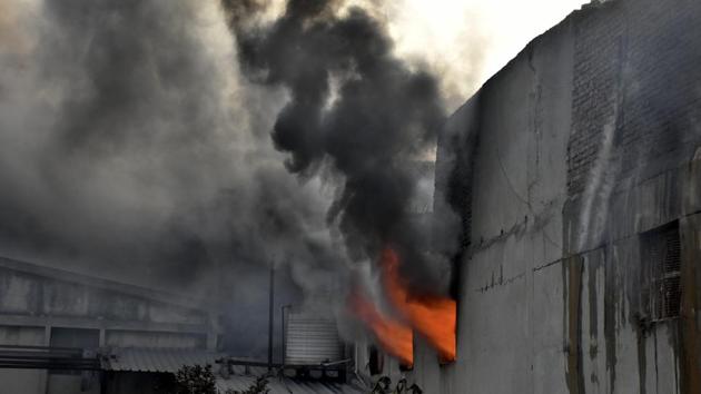 Firefighters trying to control fire at SK Bikes, Phase 7, Focal point area in Ludhiana on Thursday.(Harsimar Pal Singh/HT)