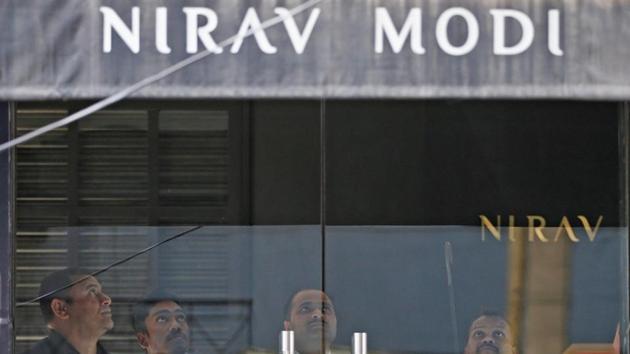 Security guards stand inside a Nirav Modi showroom during a raid by the Enforcement Directorate in New Delhi.(Photo: Reuters)