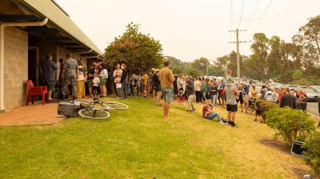 People lining up to register for evacuation by HMAS Choules in Mallacoota during bushfire relief efforts. At least 18 people are now known to have died in one of Australia’s most devastating bushfire seasons yet, and there are growing fears the toll could rise dramatically, with officials in Victoria saying 17 people were missing in the state. (Shane Cameron/ROYAL AUSTRALIAN NAVY/AFP) People lining up to register for evacuation by HMAS Choules in Mallacoota during bushfire relief efforts. At least 18 people are now known to have died in one of Australia’s most devastating bushfire seasons yet, and there are growing fears the toll could rise dramatically, with officials in Victoria saying 17 people were missing in the state. (Shane Cameron/ROYAL AUSTRALIAN NAVY/AFP)