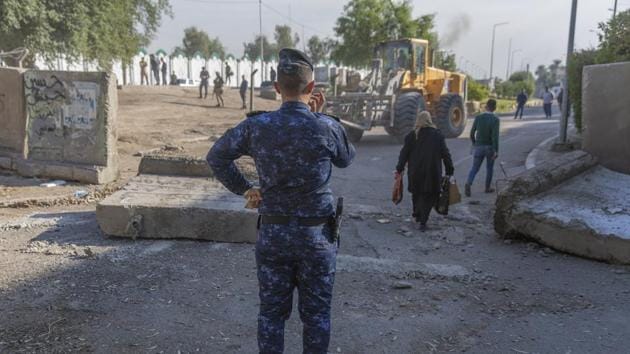 Three rockets fell on Baghdad airport on Friday. An Iraqi police officer instructs a bulldozer while Iraqi security forces remove cement blocks and opened the streets, that were closed for security concerns, around the Green Zone in Baghdad, Iraq, Thursday. (AP (Representative Picture)) Three rockets fell on Baghdad airport on Friday. An Iraqi police officer instructs a bulldozer while Iraqi security forces remove cement blocks and opened the streets, that were closed for security concerns, around the Green Zone in Baghdad, Iraq, Thursday. (AP (Representative Picture))