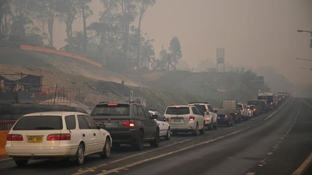 Cars line up to leave the town of Batemans Bay in New South Wales. The unprecedented crisis has sparked street protests calling on the government to immediately act on climate change, which scientists say is creating a longer and more intense bushfire season. (Peter Parks/AFP) Cars line up to leave the town of Batemans Bay in New South Wales. The unprecedented crisis has sparked street protests calling on the government to immediately act on climate change, which scientists say is creating a longer and more intense bushfire season. (Peter Parks/AFP)
