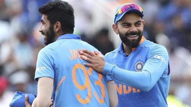 India's captain Virat Kohli, right, celebrates with teammate Jasprit Bumrah(AP)