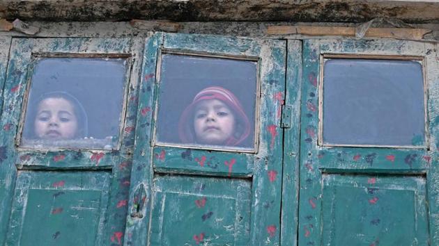 Children looking on from a mud house during a cold day on the outskirts of Srinagar. (AFP Photo) Children looking on from a mud house during a cold day on the outskirts of Srinagar. (AFP Photo)