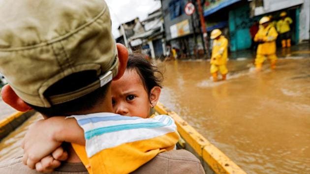 A girl is carried by her father across floodwaters in the Jatinegara area after heavy rains in Jakarta, Indonesia. (Willy Kurniawan / REUTERS) A girl is carried by her father across floodwaters in the Jatinegara area after heavy rains in Jakarta, Indonesia. (Willy Kurniawan / REUTERS)