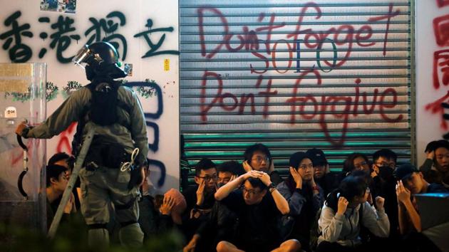 Anti-government protesters sit after being detained during a demonstration on New Year’s Day to call for better governance and democratic reforms in Hong Kong. (Navesh Chitrakar / REUTERS) Anti-government protesters sit after being detained during a demonstration on New Year’s Day to call for better governance and democratic reforms in Hong Kong. (Navesh Chitrakar / REUTERS)