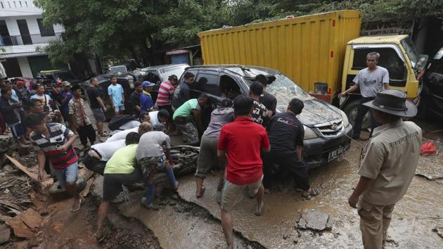 Residents try to move the wreckage of cars that were swept away by flood in Bekasi, West Java, Indonesia, Friday, Jan. 3, 2020.Severe flooding in greater Jakarta has killed scores of people and displaced tens of thousands others, the country's disaster management agency said. (AP) Residents try to move the wreckage of cars that were swept away by flood in Bekasi, West Java, Indonesia, Friday, Jan. 3, 2020.Severe flooding in greater Jakarta has killed scores of people and displaced tens of thousands others, the country's disaster management agency said. (AP)