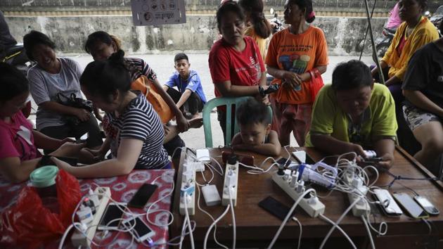 People check their phones at a charging station in Jakarta. Dewi Puspitasari worried about her one-year-old daughter’s health. “The blanket and mat I’ve got here aren’t thick enough for her and we’re scared she will get sick,” she told AFP. As Indonesians gathered for Friday prayers, a call went out for mosques to take in and help desperate refugees. (Dita Alangkara / AP) People check their phones at a charging station in Jakarta. Dewi Puspitasari worried about her one-year-old daughter’s health. “The blanket and mat I’ve got here aren’t thick enough for her and we’re scared she will get sick,” she told AFP. As Indonesians gathered for Friday prayers, a call went out for mosques to take in and help desperate refugees. (Dita Alangkara / AP)