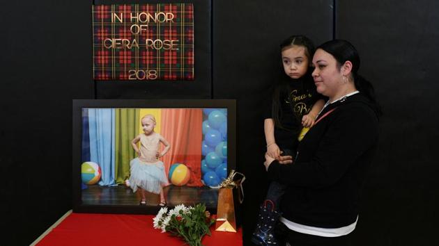 Natalie Contreras and her daughter Rosalina Chronister stand by a tribute to Contreras' deceased daughter Ciera Rose, who died aged four of cancer. A 2007 study, the most recent available, of nearly 1,000 childhood cancer cases by the University of Texas found children living within 3 km of the Houston Ship Channel had a 56% higher risk of contracting acute lymphocytic leukaemia than children living within 16 km of the channel. (Loren Elliott / REUTERS)