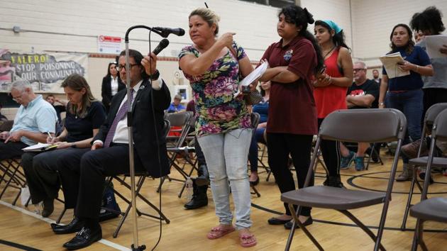 Dennys Nieto points to daughter Reyna Nieto, 14, while addressing representatives from Valero during the public hearing. For years, Dennys Nieto wanted to leave Manchester but was only recently able to afford to move to a different part of Texas. “I suffer from asthma and pain in my lungs. It feels like I’m being hit in the lungs,” Nieto told Reuters of her old neighbourhood. (Loren Elliott / REUTERS)