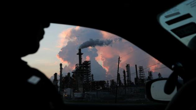 A police officer drives past a refinery in the industrial East End in Pasadena, Texas. Some residents have told Reuters that the air has a chemical-based smell that they find hard to describe but disappears once they drive a few miles away from the homes that stretch along the Houston Ship Channel, a waterway connecting the plants to the ocean. (Loren Elliott / REUTERS)
