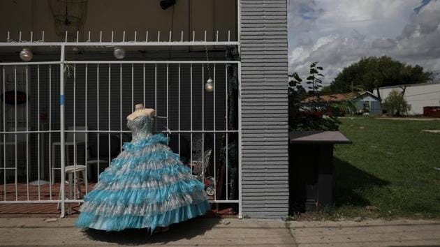 A quinceanera dress is displayed on a sidewalk in front of a shop in Houston. Of the other plants bordering Manchester, Goodyear Tire and Rubber Co has the second highest rating for compliance with environmental regulations, Keese said. Goodyear “implemented several changes that resulted in lower emissions from our facility,” Connie Deibel, a company spokeswoman told Reuters. (Loren Elliott / REUTERS)
