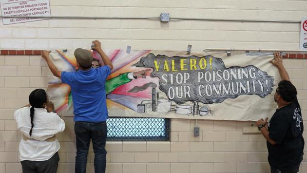 Environmental advocates from the Texas Environmental Justice Advocacy Series organization put up an anti-Valero sign before a public hearing regarding a Valero permit to legally release hydrogen cyanide. Researchers’ analysis suggests an association between childhood leukemia and air pollution. However the study could not prove the pollutants caused the illnesses. (Loren Elliott / REUTERS)