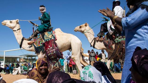 Nomads parade on camels in the Agadez stadium under the songs of Tuareg women, on the occasion of the Grand Marathon du Ténéré, the first marathon in the history of Niger. (Nora Schweitzer / AFP) Nomads parade on camels in the Agadez stadium under the songs of Tuareg women, on the occasion of the Grand Marathon du Ténéré, the first marathon in the history of Niger. (Nora Schweitzer / AFP)