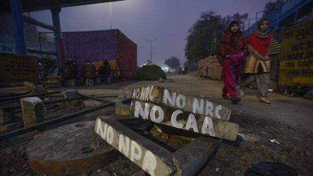 Graffiti on cemented blocks are seen near a sit-in demonstration against National Register of Citizens (NRC) and recently-passed Citizenship Amendment Act (CAA), at Shaheen Bagh, in New Delhi. (Burhaan Kinu / HT Photo)