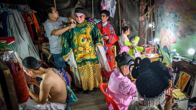 Actors prepare for a Chinese opera performance by Thailand’s Sai Bo Hong troupe on a makeshift stage at a street festival in Bangkok, Thailand. (Mladen Antonov / AFP) Actors prepare for a Chinese opera performance by Thailand’s Sai Bo Hong troupe on a makeshift stage at a street festival in Bangkok, Thailand. (Mladen Antonov / AFP)