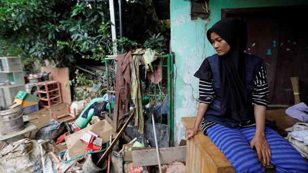A woman looks at her belongings, sitting outside her house at a flooded residential area in Bekasi, West Java province, Indonesia. Rescuers mounted a renewed search on Friday for those missing after torrential rains unleashed flash floods and landslides, killing at least 53 people across the Jakarta region as authorities raced to prevent disease outbreaks. (Willy Kurniawan / REUTERS) A woman looks at her belongings, sitting outside her house at a flooded residential area in Bekasi, West Java province, Indonesia. Rescuers mounted a renewed search on Friday for those missing after torrential rains unleashed flash floods and landslides, killing at least 53 people across the Jakarta region as authorities raced to prevent disease outbreaks. (Willy Kurniawan / REUTERS)