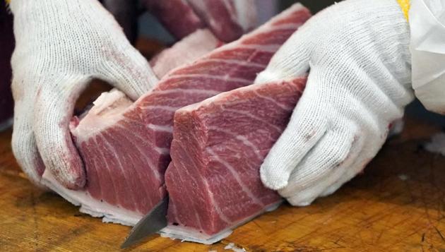 Employees cut a newly-purchased tuna at a Sushizanmai restaurant, operated by Kiyomura Corp., in Tokyo, Japan, on Sunday, Jan. 5, 2020. A bluefin tuna weighing a staggering 276 kilograms (608 pounds) was sold for 193.2 million yen ($1.79 million) on Sunday at a Tokyo fish market, the second-highest price on record. (Bloomberg) Employees cut a newly-purchased tuna at a Sushizanmai restaurant, operated by Kiyomura Corp., in Tokyo, Japan, on Sunday, Jan. 5, 2020. A bluefin tuna weighing a staggering 276 kilograms (608 pounds) was sold for 193.2 million yen ($1.79 million) on Sunday at a Tokyo fish market, the second-highest price on record. (Bloomberg)