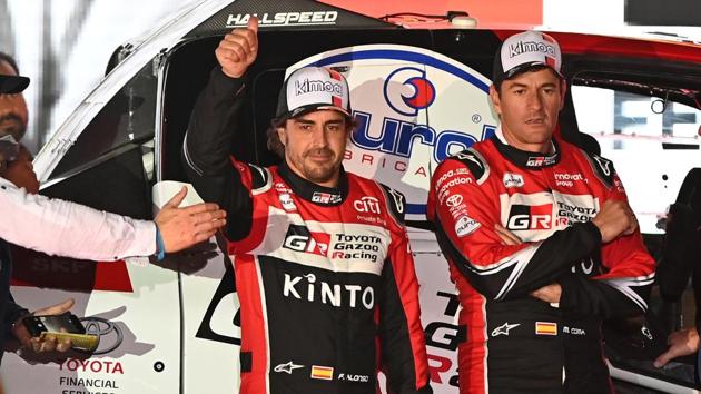 Fernando Alonso and Marc Coma of Toyota Gazoo Racing during a presentation.(REUTERS)