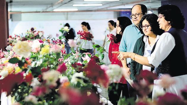 People admire roses at an exhibition organised by Rose Society of Pune at the Tilak University, Mukundanagar. The exhibition is also open on Sunday from 9 am to 8 pm.(Ravindra Joshi/HT PHOTO)