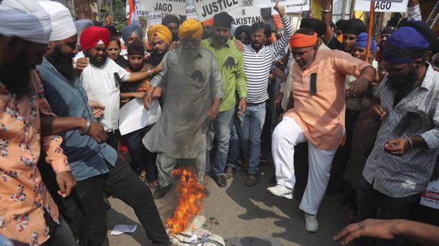 Sikh protestors stamp on a burning effigy of Pakistan Prime Minister Imran Khan during a protest against the alleged vandalism and stoning of the Nankana Saheb, a Sikh shrine in Pakistan, in Hyderabad.(AP)