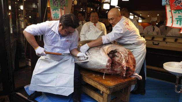 A sushi chef cuts a bluefin tuna at a restaurant at Tsukiji market area in Tokyo, Sunday, Jan. 5, 2020, after it was sold at the first auction of 2020 at Tokyo's Toyosu fish market. (AP) A sushi chef cuts a bluefin tuna at a restaurant at Tsukiji market area in Tokyo, Sunday, Jan. 5, 2020, after it was sold at the first auction of 2020 at Tokyo's Toyosu fish market. (AP)