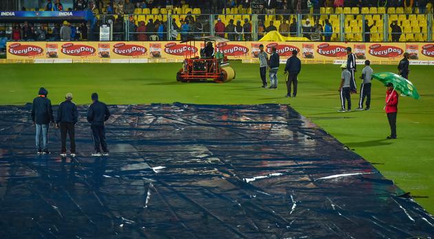 Groundsmen cover their pitch due to rain.(PTI)