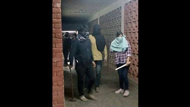 First reports of violence inside JNU emerged around 7.30pm. Videos showed groups of masked individuals entering hostels with bats and hammers. The JNU Students’ Union (JNUSU) accused the Akhil Bharatiya Vidyarthi Parishad (ABVP), the student wing of the Rashtriya Swayamsevak Sangh, for the attack. (ANI) First reports of violence inside JNU emerged around 7.30pm. Videos showed groups of masked individuals entering hostels with bats and hammers. The JNU Students’ Union (JNUSU) accused the Akhil Bharatiya Vidyarthi Parishad (ABVP), the student wing of the Rashtriya Swayamsevak Sangh, for the attack. (ANI)
