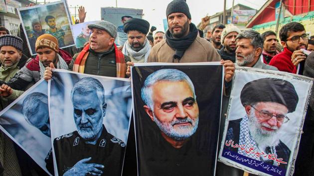 Shia Muslims carry photographs of the killed Iranian military commander Qasem Soleimani as they take part in a protest against the US Air strike on Iraq military base.(PTI Photo)