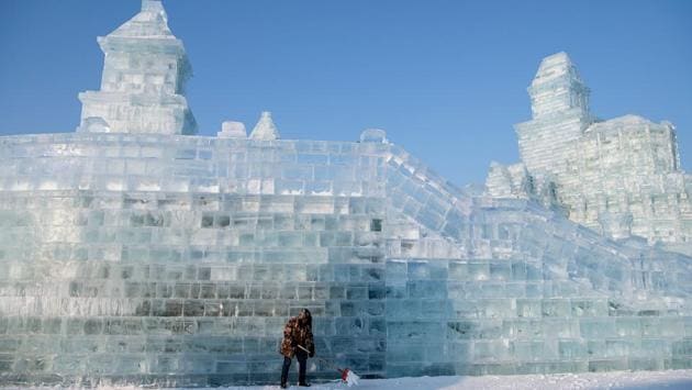 A worker shovels ice in front of an ice sculpture at the Harbin Ice and Snow World festival in Harbin. This year’s Harbin International Ice and Snow Festival in the province of Heilongjiang required 170,000 cubic metres (six million cubic feet) of ice harvested from the Songhua River by more than 100 workers. (Noel Celis/AFP) A worker shovels ice in front of an ice sculpture at the Harbin Ice and Snow World festival in Harbin. This year’s Harbin International Ice and Snow Festival in the province of Heilongjiang required 170,000 cubic metres (six million cubic feet) of ice harvested from the Songhua River by more than 100 workers. (Noel Celis/AFP)