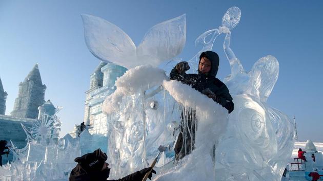 Ice sculptors give finishing touches on an ice sculpture at the Harbin Ice and Snow World festival in Harbin. Fireworks marked the festival’s opening on Sunday night as tourists wandered between colourfully illuminated ice towers and monuments in the northeastern city. Earlier in the day, 43 brides in lace wedding gowns and down jackets waited in line with grooms to take part in a “mass ice and snow wedding”. (Noel Celis/AFP) Ice sculptors give finishing touches on an ice sculpture at the Harbin Ice and Snow World festival in Harbin. Fireworks marked the festival’s opening on Sunday night as tourists wandered between colourfully illuminated ice towers and monuments in the northeastern city. Earlier in the day, 43 brides in lace wedding gowns and down jackets waited in line with grooms to take part in a “mass ice and snow wedding”. (Noel Celis/AFP)
